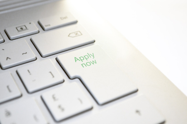 White keyboard with "Apply now" written on big button in green letters